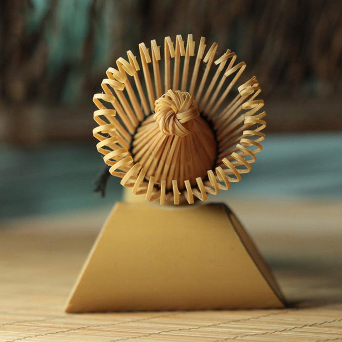 a close up of a flower in a vase on a table